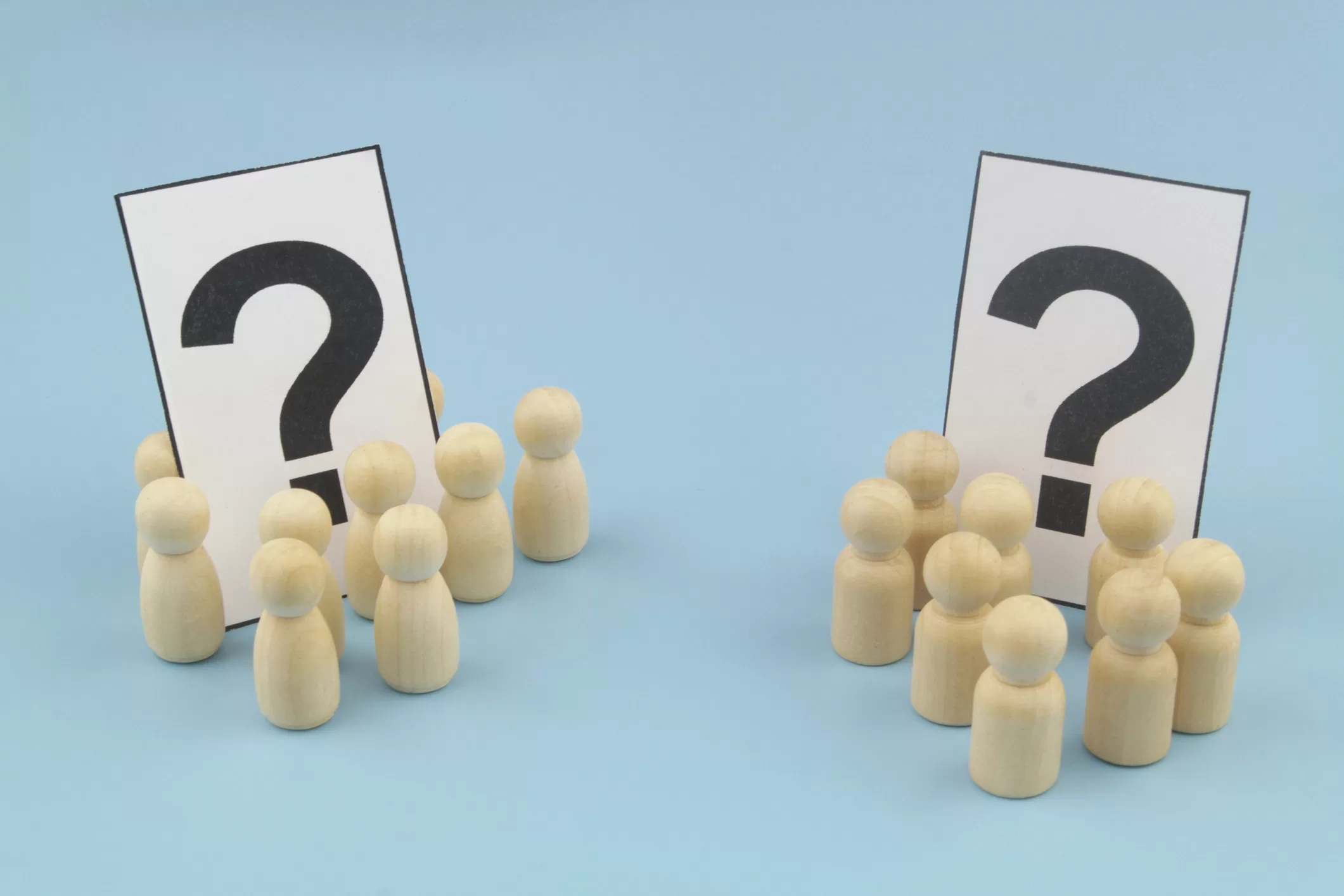 Wooden people with question marks