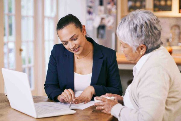 Image related to 2 women reviewing a document.