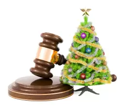Judge gavel next to a small christmas tree