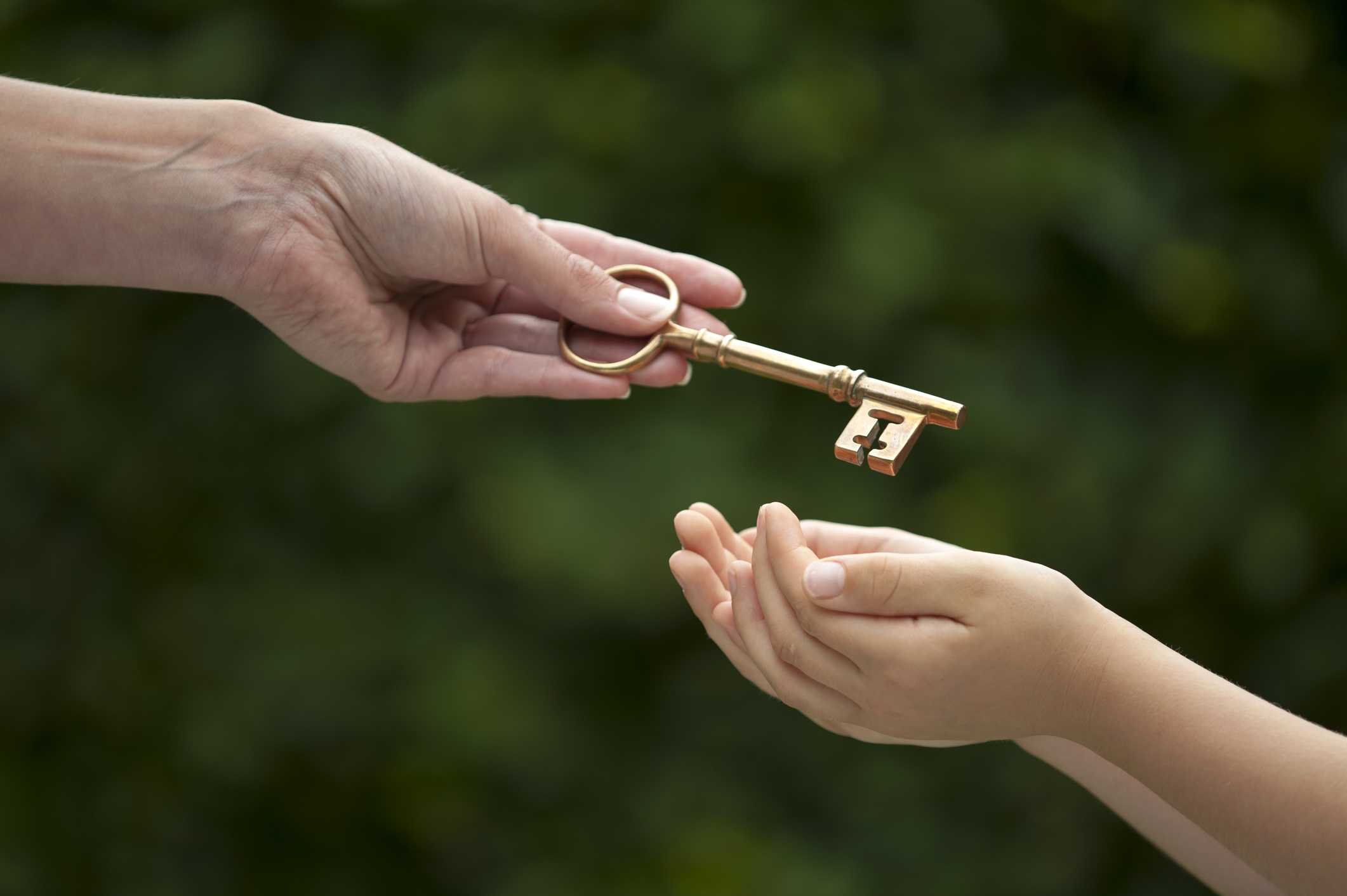 Person handing a child a key