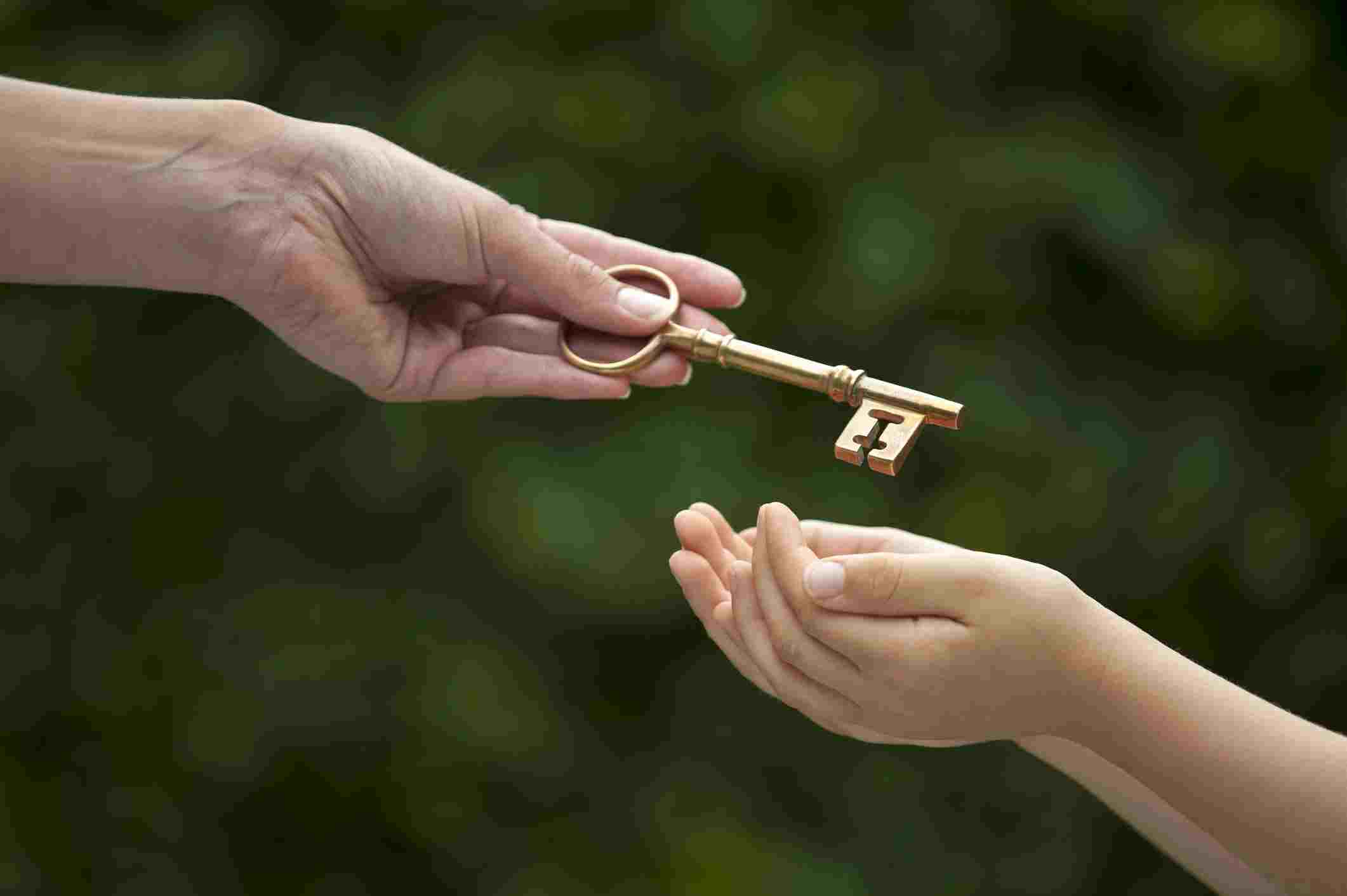 Person handing a child a key